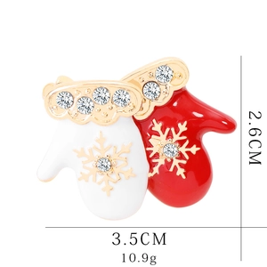 Detailed view of a red and white enamel Christmas glove brooch with rhinestones and size data
