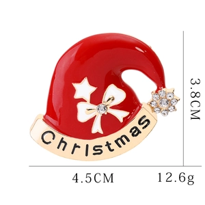 Detail of red Christmas hat brooch with white bow, gold banner, and size dimensions