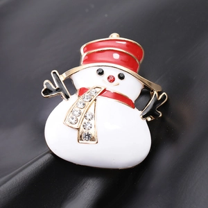 Detail of a festive enamel snowman brooch with red hat and sparkling rhinestones