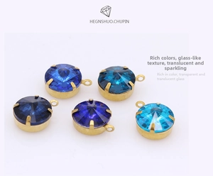 Close-up of circular blue faceted glass pendants with gold claw settings for DIY jewelry