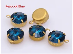 Detailed view of peacock blue faceted round crystals with gold metal claw settings for DIY