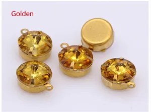Macro shot of 5 golden yellow round claw-set rhinestones for DIY jewelry making