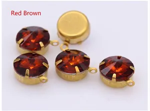 Macro detail of reddish brown faceted glass crystals in gold claw settings for DIY jewelry