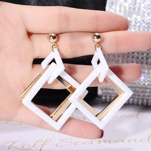 Retro geometric acrylic earrings featuring white square frames and gold metal accents
