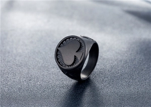 Macro shot of matte black spade signet ring with radial grooved details for men