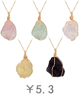 Detailed view of five natural raw crystal pendants with golden wire wrapped craft
