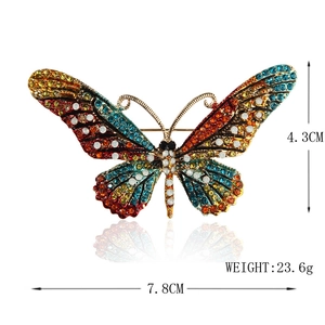 Colorful rhinestone butterfly brooch with dimensions 7.8cm by 4.3cm in gold finish
