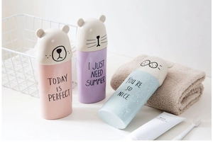 Close-up of cute cartoon portable travel toothbrush cases in pink, blue, and purple