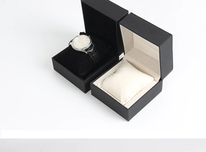 Detail view of premium watch storage box with black and beige velvet lining and pillows