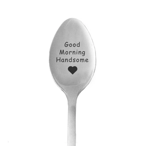 Macro shot of stainless steel spoon engraved with Good Morning Handsome and heart