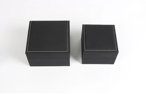 Top view of two black leather watch boxes with elegant white stitching details