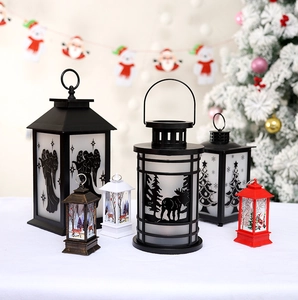 Detailed view of Christmas lanterns in multiple sizes and colors on a festive tabletop