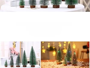 Close-up of mini artificial pine trees with white snow effect and wooden base stands