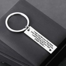 Macro detail of engraved stainless steel keychain for Father's Day on a gift box