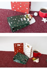 Close-up of festive Christmas paper gift bags in red, green, and white with holiday patterns