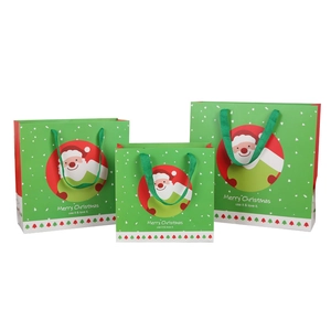 Green Christmas gift bags with Santa Claus graphics in three sizes with ribbon handles