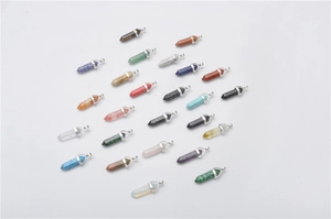 Assorted hexagonal quartz point pendants in various colors on a white background