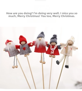 Detailed view of five handcrafted Christmas wooden figures with red hats and knitted decor