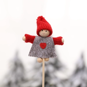 Miniature wooden Christmas elf doll with red knit hat and heart detail on a stick
