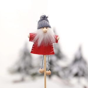 Mini Christmas gnome decoration with red felt suit and grey knit hat on wooden stick