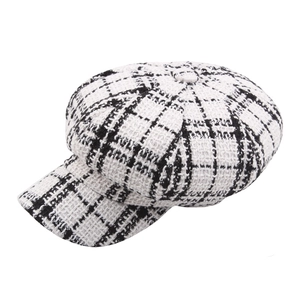 Vintage black and white tweed newsboy cap with classic checkered pattern and button top