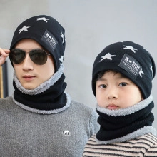 Close-up of winter knit beanie and neck warmer set with white star patterns and fleece lining