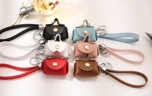 Mini PU leather keychain wallets in six colors with gold snap buttons and wrist straps