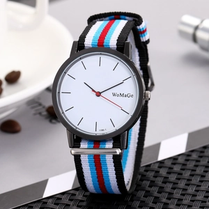 Minimalist watch with black alloy case and vibrant striped nylon woven strap on table