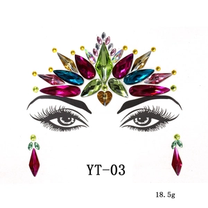 Close-up of colorful acrylic crystal face jewels and teardrop stickers for masquerade