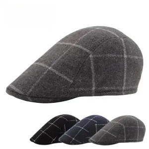 Detail of wool blend plaid newsboy caps in charcoal grey black and navy blue colors