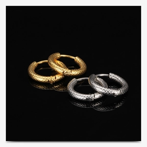 Macro shot of 3mm gold and silver textured mesh hoop earrings on a black reflective surface