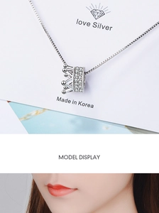 Detail of silver crown necklace with zircons and model display showing neck fit