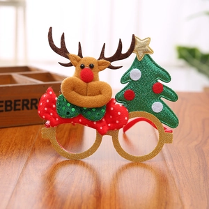 Detail of Christmas glasses with reindeer plush antlers and glittery green tree decor