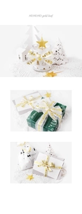 Close-up of Christmas HOHO gold foil ribbon with deer gift boxes and holiday decorations