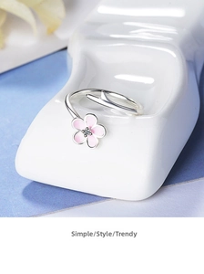 Detail of the cherry blossom ring with pink enamel petals and a small zircon center