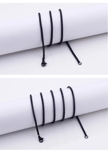 Detail of a black stainless steel box chain with a secure lobster clasp and metal texture