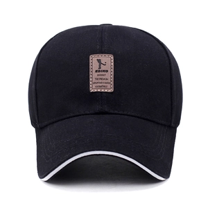 Classic black cotton baseball cap with white piping and brown leather patch on front