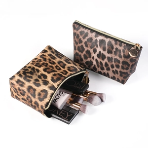 Macro view of leopard print cosmetic bags showing spacious interior and gold zipper