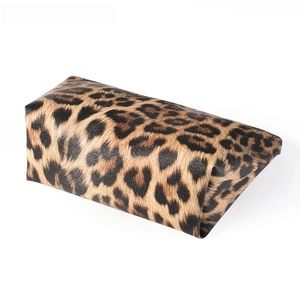 Detailed close-up of a leopard print travel toiletry bag with high-quality PU leather texture