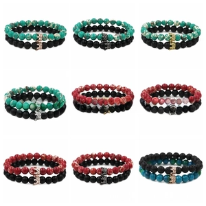 Detail showing various double-layer natural stone bead bracelets with alloy crown charms