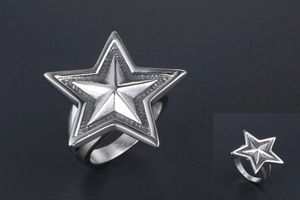 Macro shot of punk titanium steel ring featuring a large polished pentagram star design
