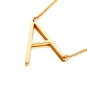 Detailed view of a polished gold letter A initial pendant necklace on a clean white base