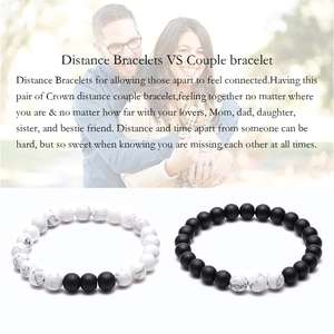 Detail view of 8mm tiger eye stone and white turquoise couple distance bracelets