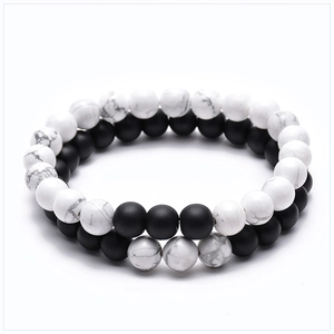 Detail of 8mm tiger eye and matte stone bracelets with white turquoise beads