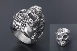 Macro detail of men's punk skull ring showing intricate helmet design and silver finish