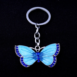 Detailed view of silver butterfly keychain with sky blue enamel and dark blue rhinestones