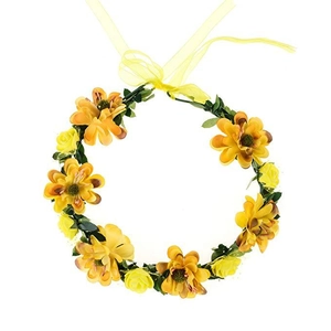 Detail of yellow artificial roses and green leaves on a bridal wreath with ribbon