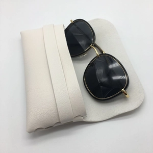 Black round lens sunglasses with gold metal frame and white lychee leather pouch