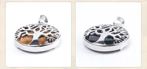Detailed view of silver Tree of Life pendants with Tiger Eye and Blue Sandstone inlay