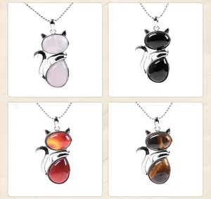 Detailed close-up of cat-shaped stone pendants in rose quartz, obsidian, agate and tiger eye